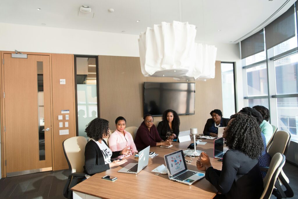 Group of professionals engaged in a strategic meeting in a modern office setting.